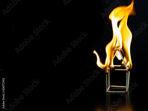 Burning match house with black background, fire house model property Insurance