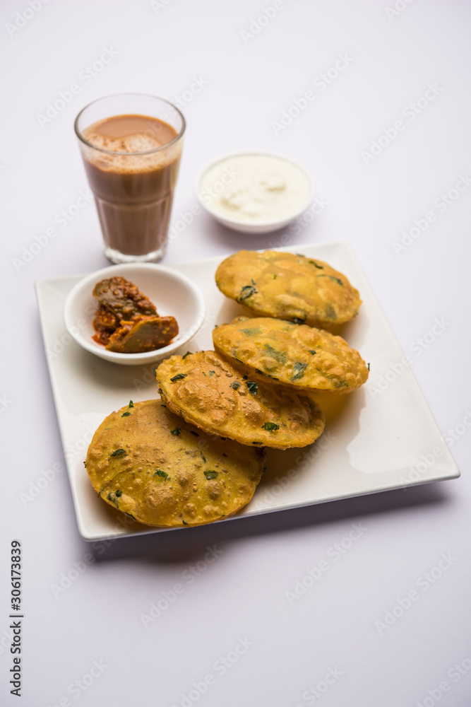 Methi Poori or Puri made using Fresh fenugreek leaves missed with wheat flour, by making small pancake size shapes deep fried in oil, served with tea Methi Poori or Puri made using Fresh fenugreek leaves missed with wheat flour, by making small pancake size shapes deep fried in oil, served with tea