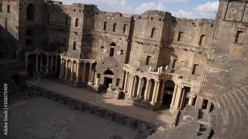 Panning shot, showing the Bosra Amphitheater in Syria. photo