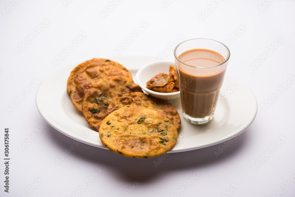 Methi Poori or Puri made using Fresh fenugreek leaves missed with wheat flour, by making small pancake size shapes deep fried in oil, served with tea Methi Poori or Puri made using Fresh fenugreek leaves missed with wheat flour, by making small pancake size shapes deep fried in oil, served with tea