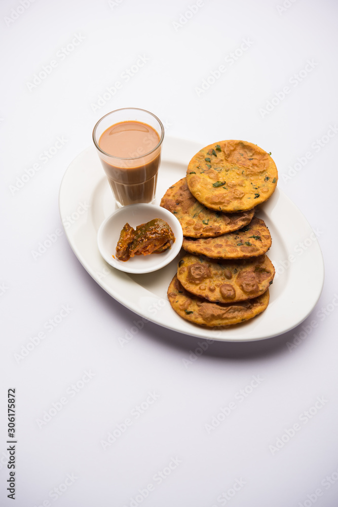 Methi Poori or Puri made using Fresh fenugreek leaves missed with wheat flour, by making small pancake size shapes deep fried in oil, served with tea Methi Poori or Puri made using Fresh fenugreek leaves missed with wheat flour, by making small pancake size shapes deep fried in oil, served with tea