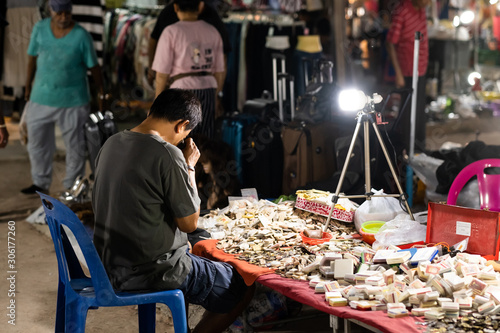 man watching amulets on amulet market