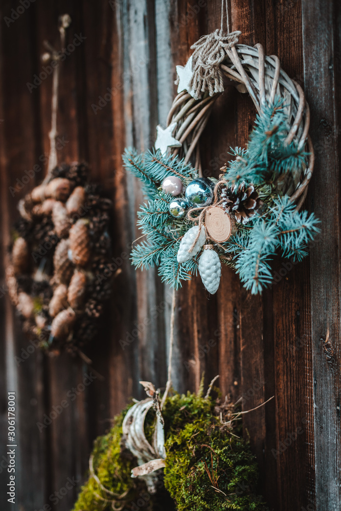 festive rustic wreath of cones on a dark brown wooden background. The concept of the Christmas holiday and new year.