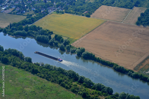 Rosny sur Seine, France - july 7 2017 : aerial photography of a barge on the Seine riverside photo