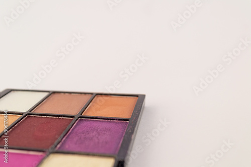 Makeup in product container isolated on white background. Colorful pallet