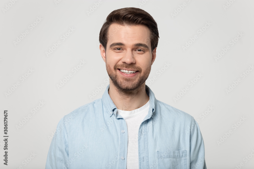 Portrait of smiling Caucasian man posing on grey background Portrait of smiling Caucasian man posing on grey background