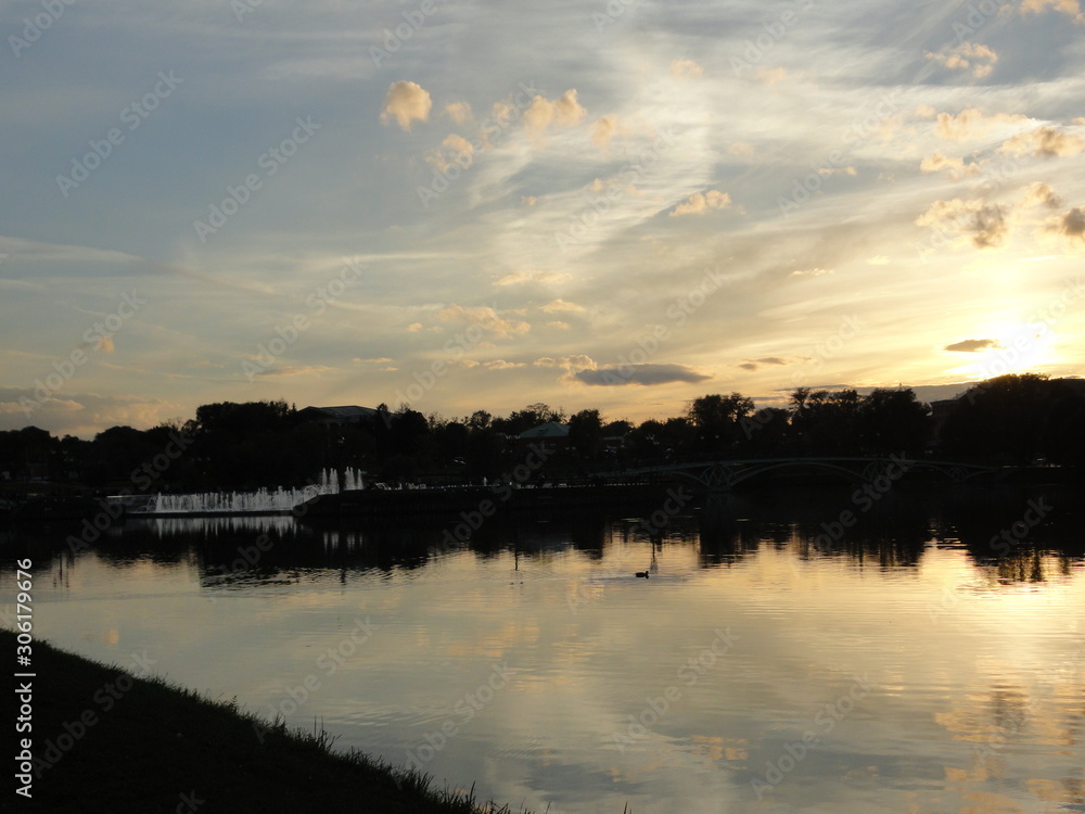 river at sunset, clouds reflected in the water