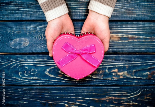 Girl holding a gift box in the form of heart