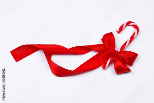 Christmas candy cane with red bow on white background. Christmas holiday sweet decoration concept. Part of set.