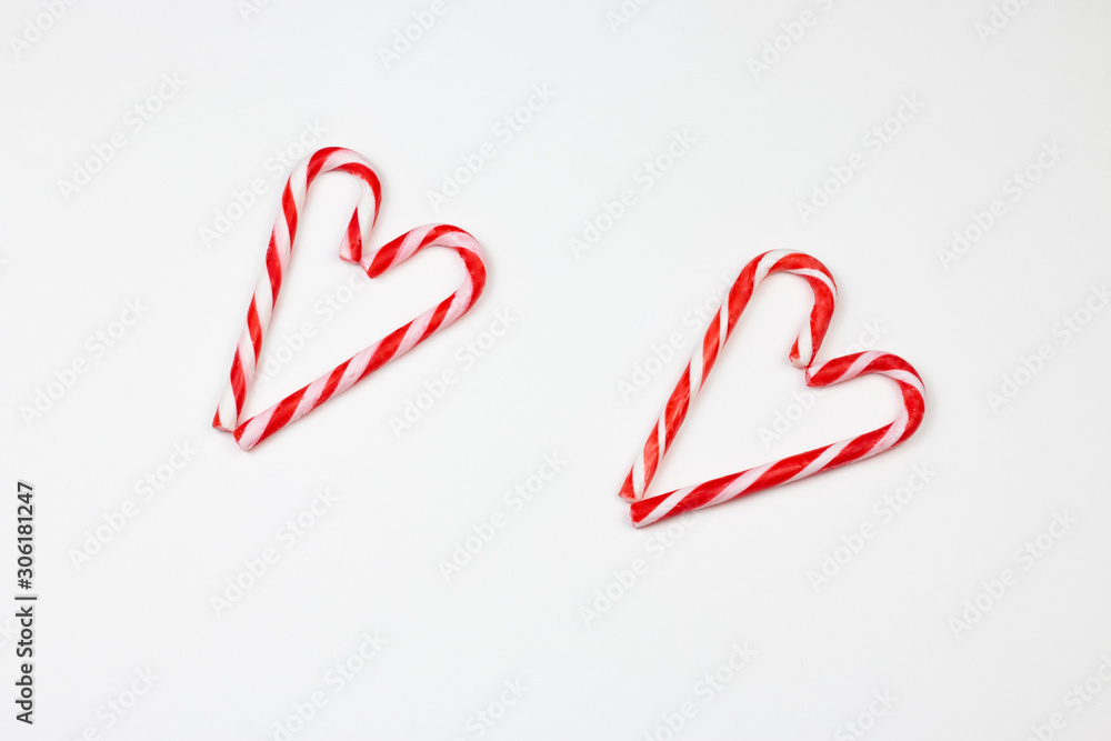 Christmas candy canes in heart shape. Two Christmas candy cans in heart shape. Christmas and Valentin day concept. Part of set. Christmas candy canes in heart shape. Two Christmas candy cans in heart shape. Christmas and Valentin day concept. Part of set.