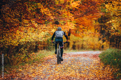 MTB Biker Ride in colorful autumn forest.