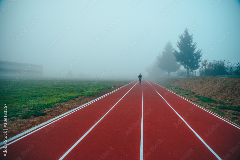 Running track over blue misty sky. Morning run concept photo. Running track over blue misty sky. Morning run concept photo.