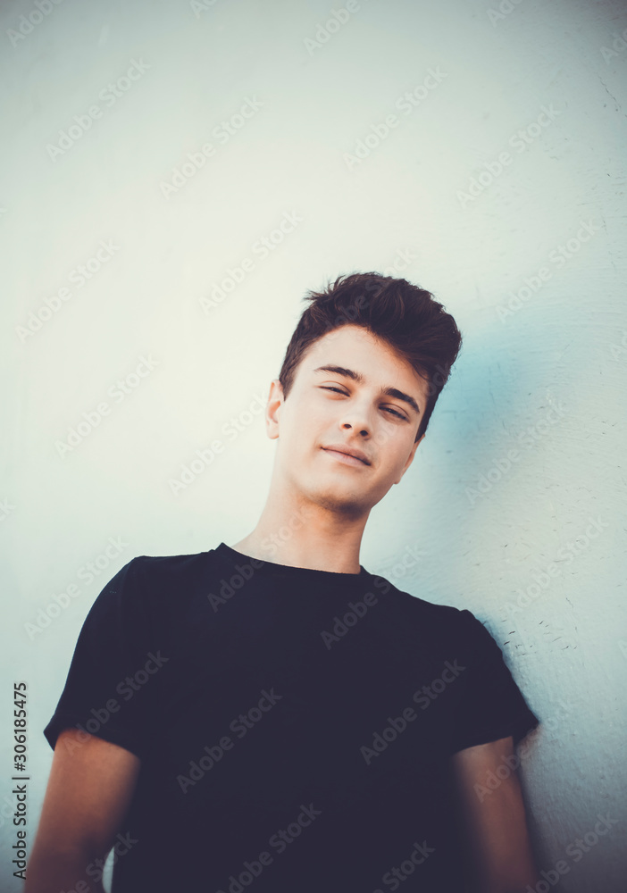 Young attractive man posing in front of camera in a black t-shirt Young attractive man posing in front of camera in a black t-shirt