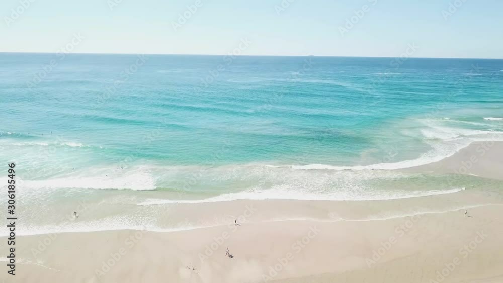 Drone Panning Above Transparent Turquoise Ocean Water By A Sandy Beach Coastline In Australia At Sunrise Drone Panning Above Transparent Turquoise Ocean Water By A Sandy Beach Coastline In Australia At Sunrise