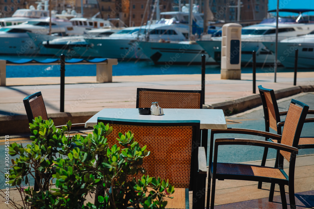 Fototapeta premium cafe near the quay with yachts and boats, travel