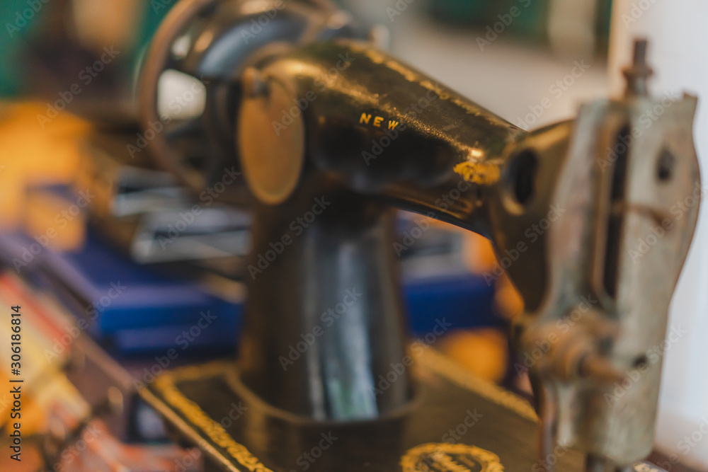 Fototapeta premium Measuring tape and old sewing machine on tailor table.