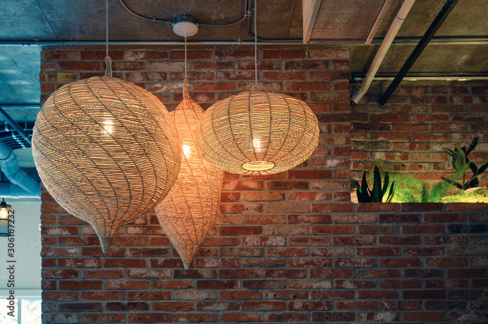 Fototapeta Wooden weave lamp hanging on ceiling and brick wall