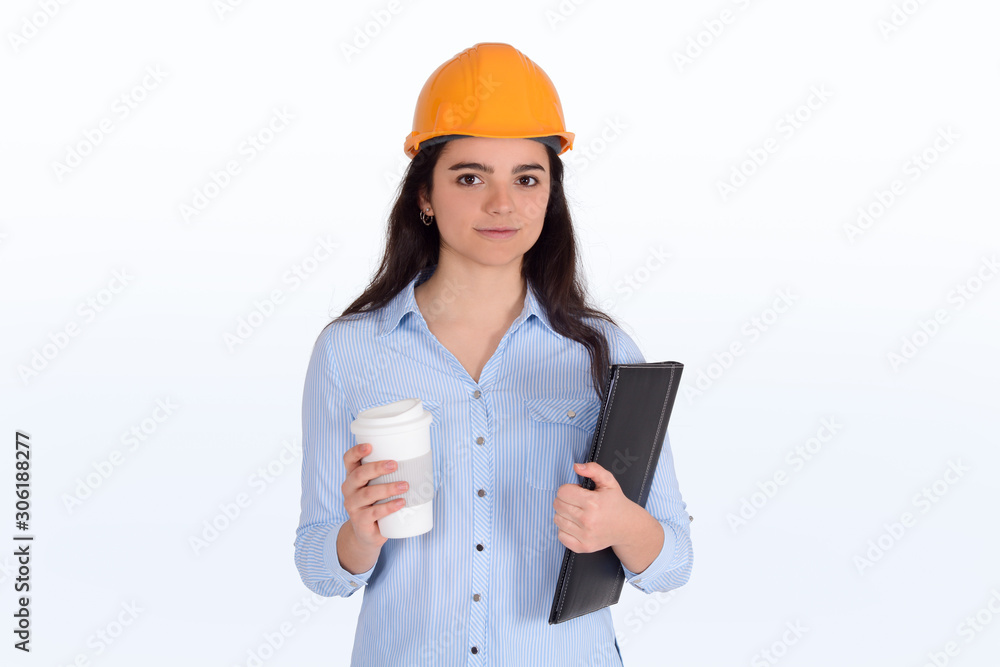Female architect holding folders with a coffee and helmet. Female architect holding folders with a coffee and helmet.