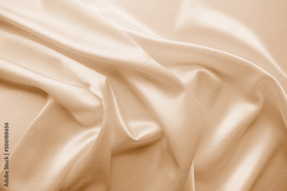 Fototapeta premium Beautiful smooth elegant wavy beige / light brown satin silk luxury cloth fabric texture, abstract background design. Copy space. Card or banner