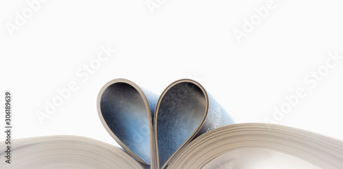  Open book with curled leaves in the shape of a heart.