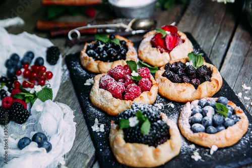 biscuit with berries of blackberry, raspberry, blueberry, black currant, strawberry