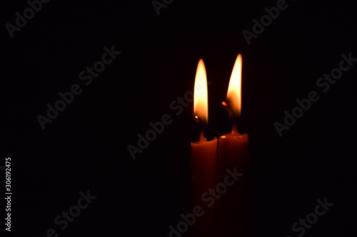 The flame of the candle in the dark