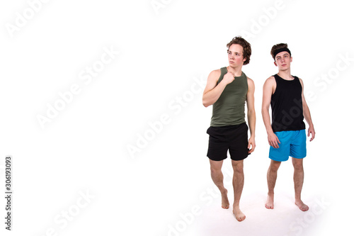 Fitness and healthy lifestyle. Two funny young guys. White background.