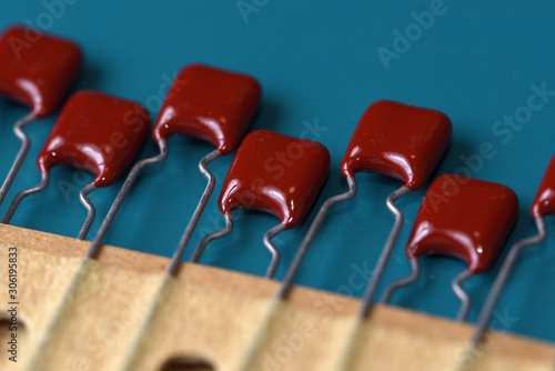 Electronic components, Red film capacitors on PCB background photo