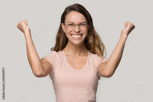 Wallpaper Mural Happy smiling young woman wearing glasses celebrating success Torontodigital.ca