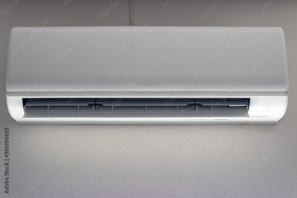 White air conditioner installed on the wall in the room White air conditioner installed on the wall in the room