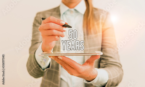 Handwriting text 50 Years. Conceptual photo Honoring Ruby Jubilee Commemorating a special day Semicentennial Business concept with mobile phone and business woman photo