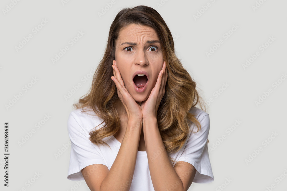 Shocked scared woman screaming, feeling afraid, looking at camera Shocked scared woman screaming, feeling afraid, looking at camera