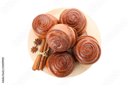 Tasty cinnamon roll with ingredients on plate isolated on white background. Top view