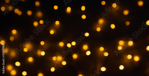 abstract golden bokeh light festive holiday on black background
