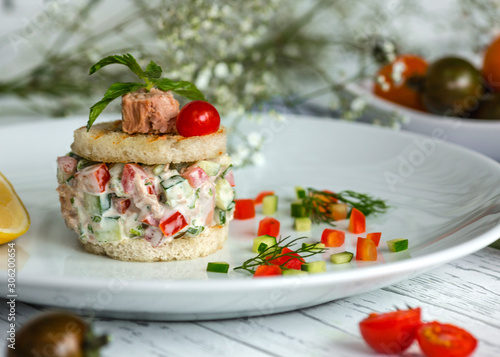 tuna salad with tomato and cucumber seasoned with mayonnaise