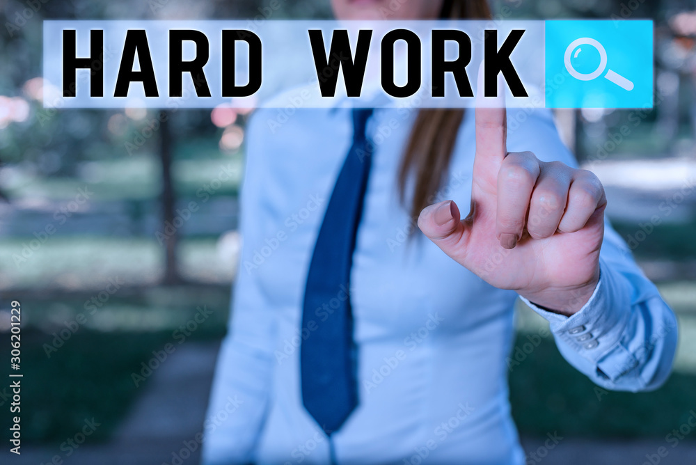 Writing note showing Hard Work. Business concept for always putting a lot of effort and care into work or endurance Handsome business girl pointing with finger into empty space Writing note showing Hard Work. Business concept for always putting a lot of effort and care into work or endurance Handsome business girl pointing with finger into empty space