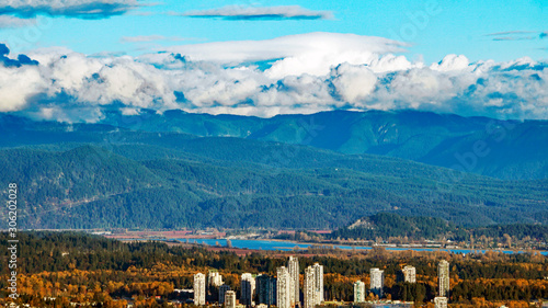 Coquitlam Town Centre against backdrop of forest-clad mountains and Fraser River