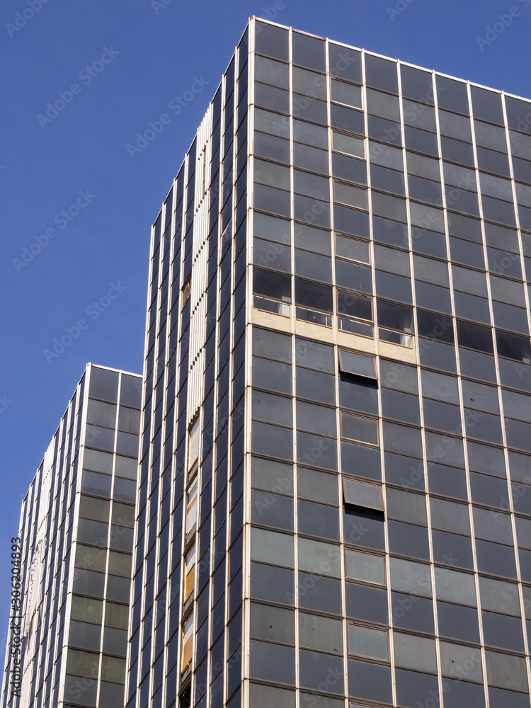 Brussels, Belgium, 10/07/2019 Old unkept sky scraper poorly maintained European office building with blue skies and rusty, dirty windows in the main business district of Brussels Brussels, Belgium, 10/07/2019 Old unkept sky scraper poorly maintained European office building with blue skies and rusty, dirty windows in the main business district of Brussels