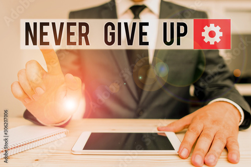 Word writing text Never Give Up. Business photo showcasing Keep trying until you succeed follow your dreams goals Male human wear formal clothes present presentation use hi tech smartphone