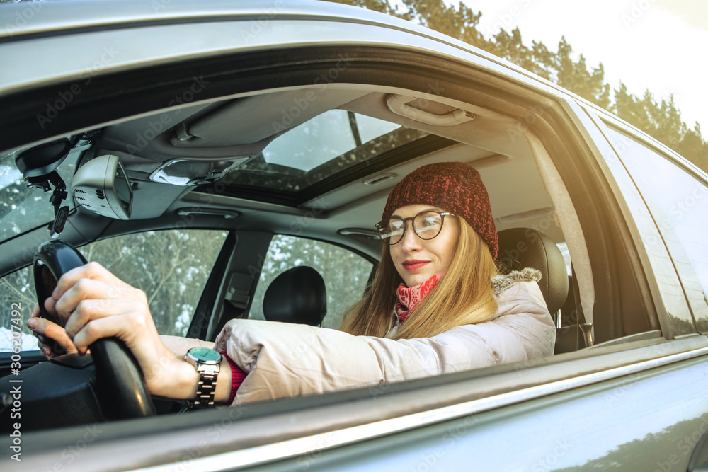 Girl beauty glasses driving car winter forest Girl beauty glasses driving car winter forest