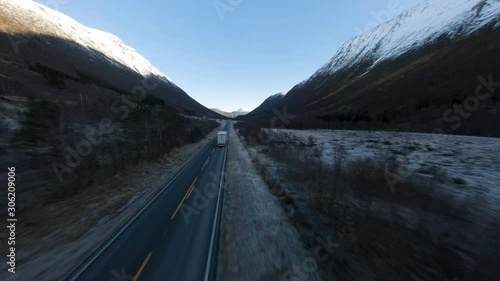 Aerial shot of semi truck driving down a mountain road in high speed. 