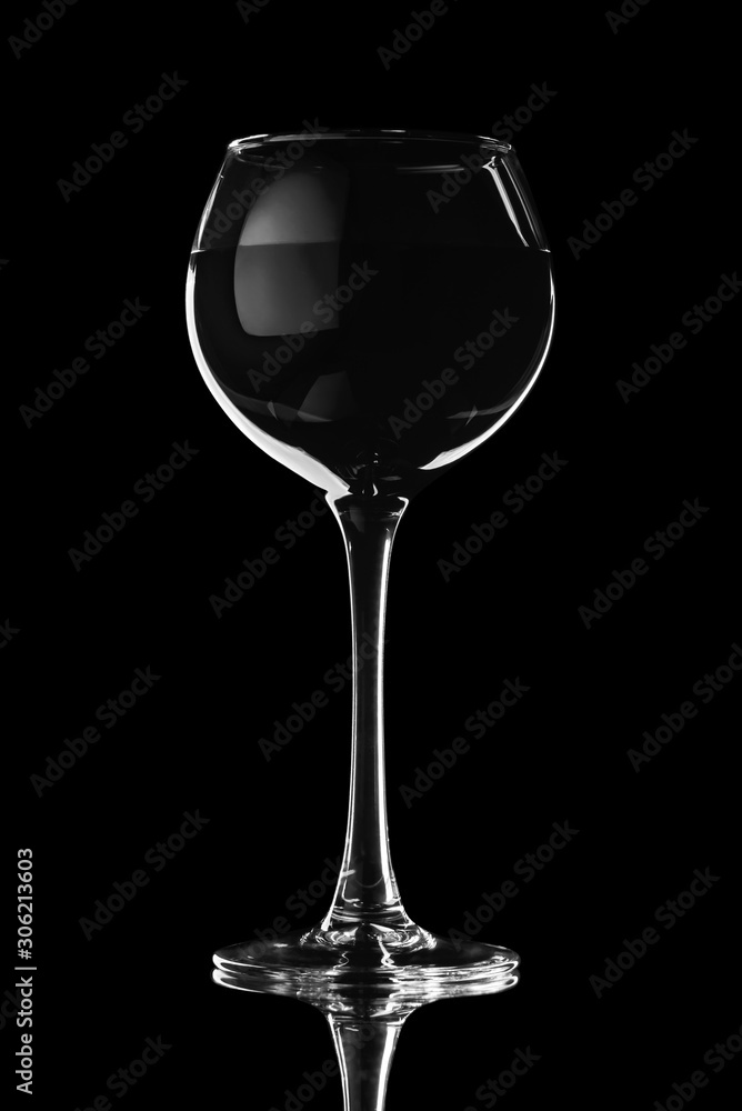 Wine glass on a black background in contrasting light