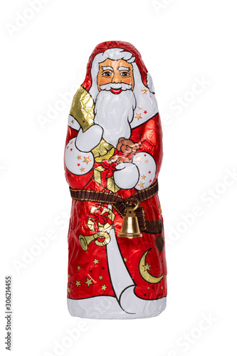 Chocolate Santa isolated. Close-up of a cheerful wrapped chocolate Santa Claus or the good Saint Nicolas figurine isolated on a white background. Macro photograph.