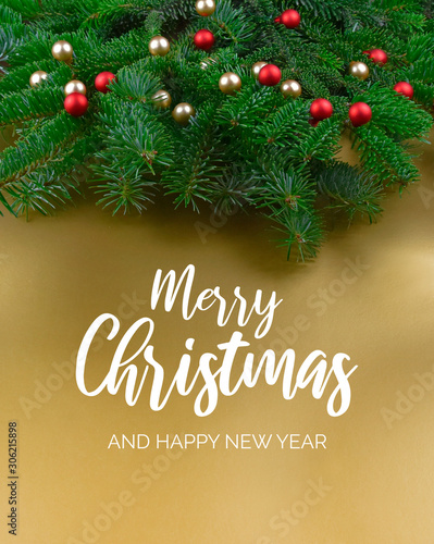 Merry Christmas and Happy New Year Sign with spruce branch. Christmas golden background with ornate spruce branch stock images. Elegant holiday background. Golden Christmas greeting card
