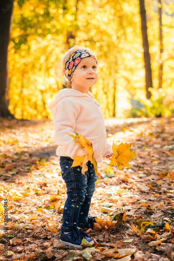 Baby girl playing autumn forest park Baby girl playing autumn forest park