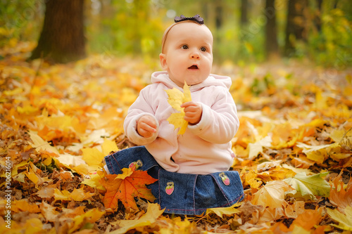 Baby girl playing autumn forest park