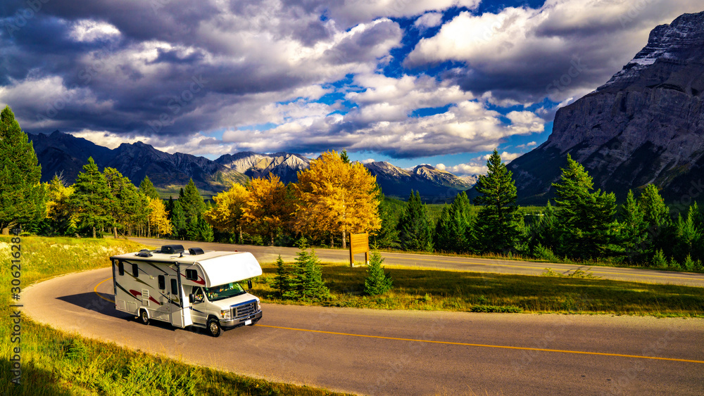 Recreational Vehicle Driving on Autumn Highway In Beautiful Mountains Wilderness - obrazy, fototapety, plakaty 