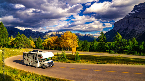 Recreational Vehicle Driving on Autumn Highway In Beautiful Mountains Wilderness