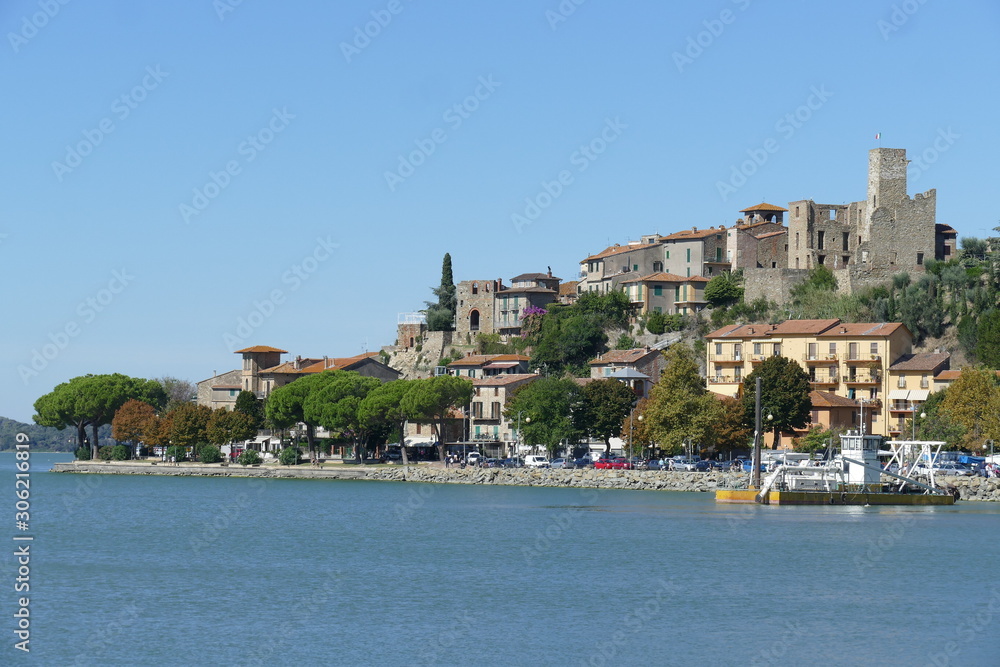 Fototapeta premium Passignano on Trasimeno Lake panorama from the port of the village built on a rocky spur around a Lombard fortification.