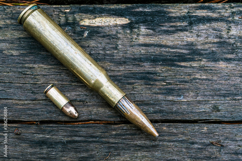 close up of bullets on wooden background. Dark colors.